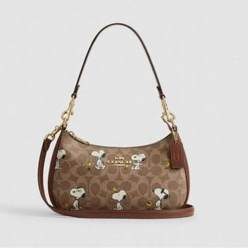 2. Coach x Peanuts Teri Shoulder Bag – Signature Canvas Snoopy Print